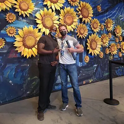 Two people in front of Sunflowers - Van Gogh Exhibit